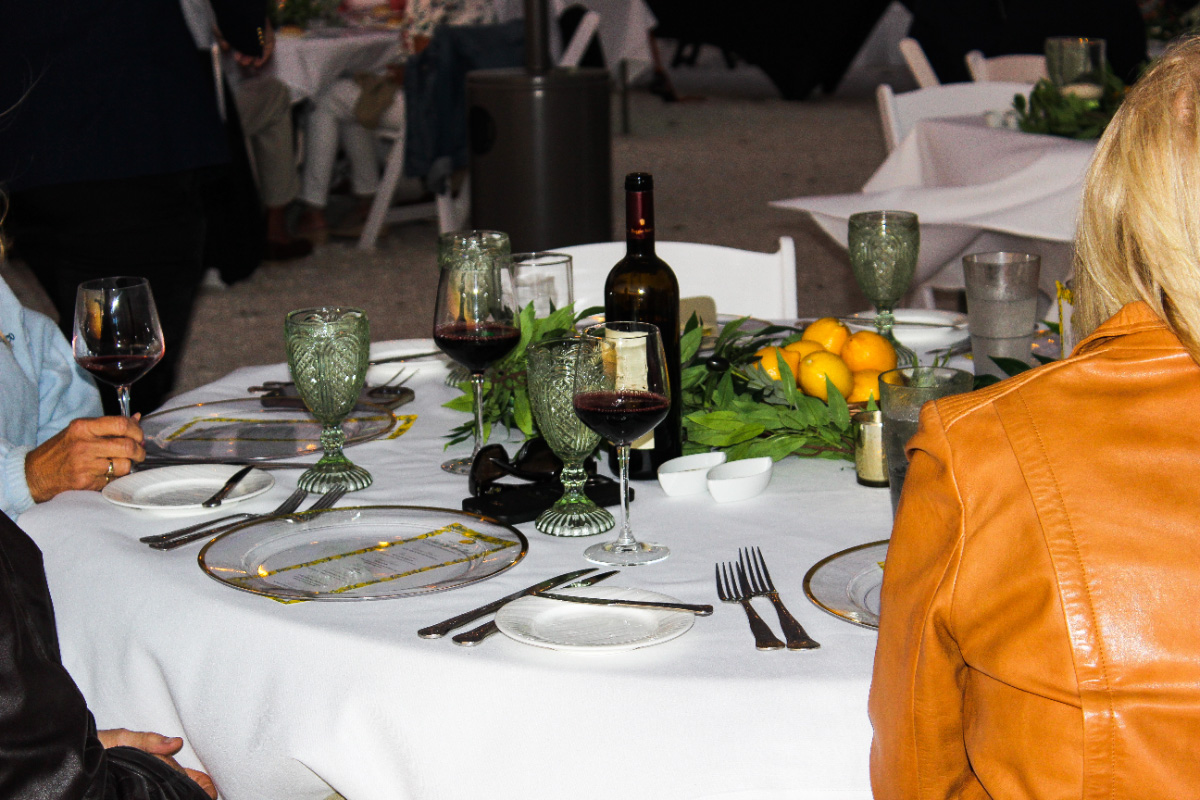 Outdoor-dinner-party-table-setting-wine-lemons–-Club-at-Barefoot-Beach