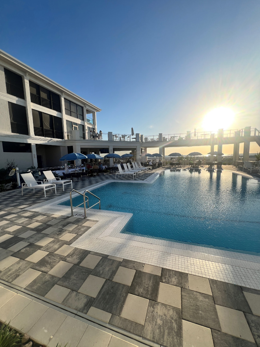 Resort-pool-deck-sunset-view–-Club-at-Barefoot-Beach